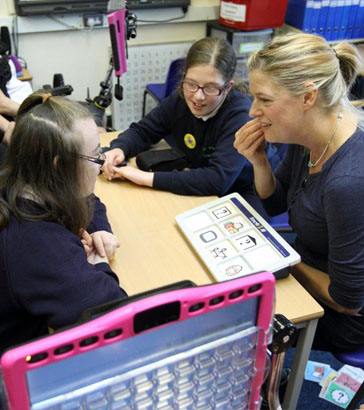 A girl and her teacher holding a small toy