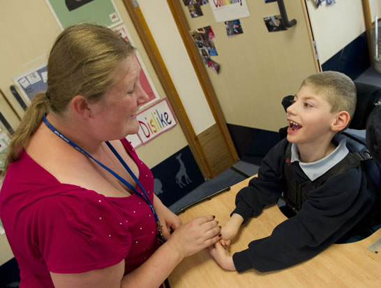 Teacher interacting with child.