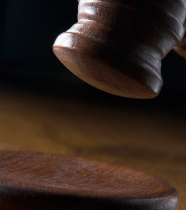 A brown gavel in use in a court of law