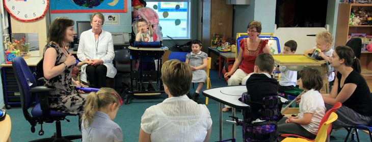 A boy and carer joining a group