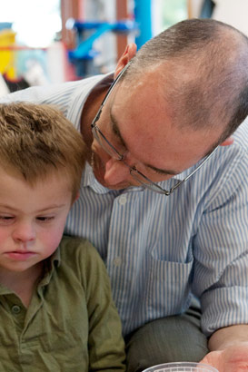 Carer showing boy two items of
                  food