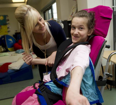 Girl in chair with carer