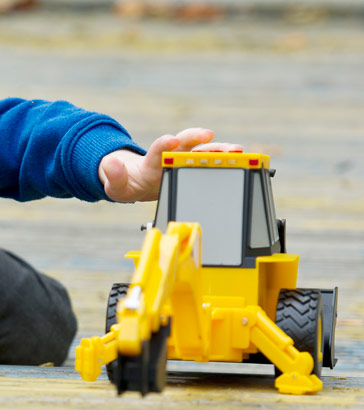 Boy playing with a toy digger