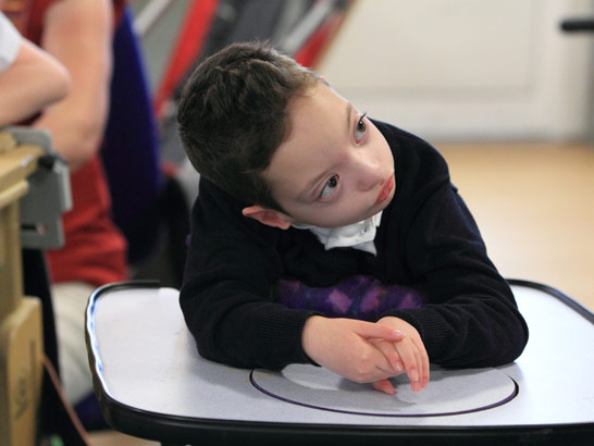 A boy in a standing support