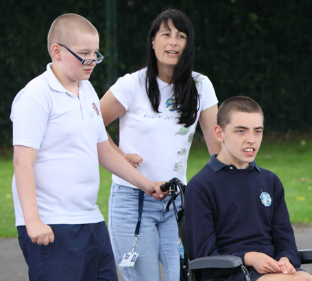 Boy in wheelchair participating in group
                  activity