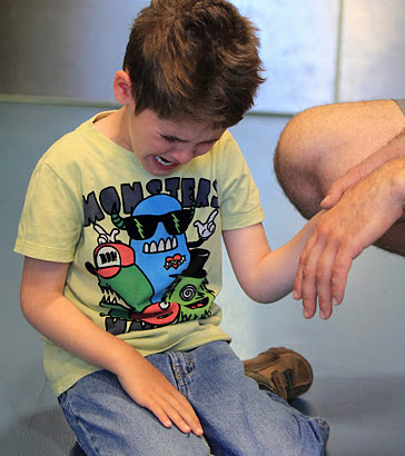 Carer holding distressed boy's hand