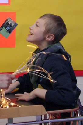 Teacher and happy pupil in walking frame
                  use sensory lights in classroom