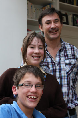 The whole family: sister and father stand
                  together with brother with complex needs