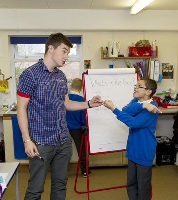 A boy holds a small plastic toy