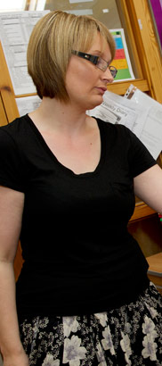 A teacher stands in her office