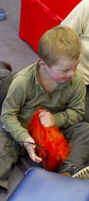 Child playing with teddy bear