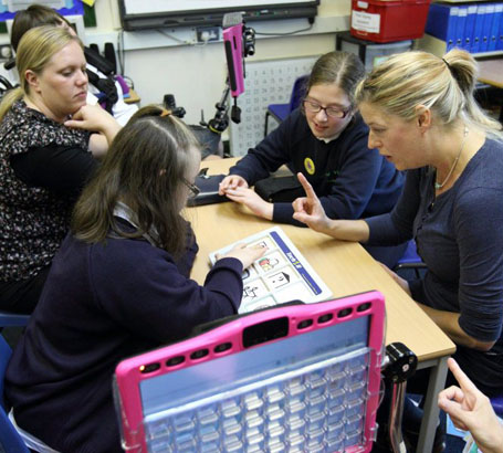 Teacher showing card to children