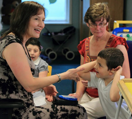 Teacher interacting with young boy