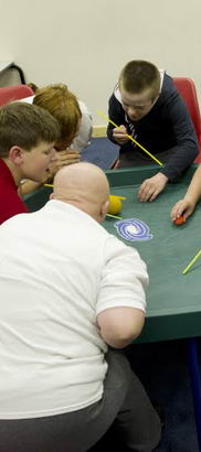 boys playing a game at a table
