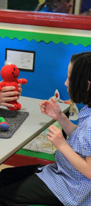 Girl playing with puppet crocodile