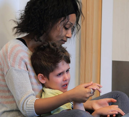 Teacher calming a boy