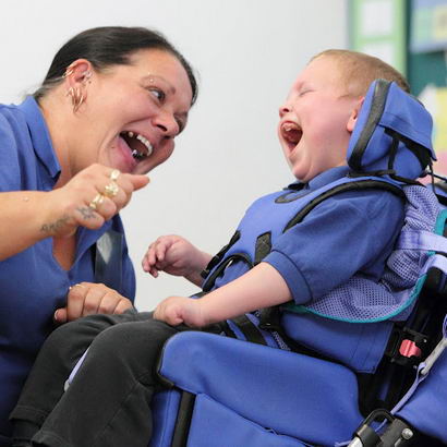 A teacher and a young boy use verbal and
                  non verbal cues to communicate