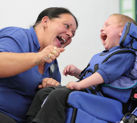 A teacher and a young boy use verbal and
                  non verbal cues to communicate