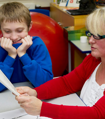 Teacher reading boy story]