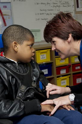 female adult with boy in wheelchair