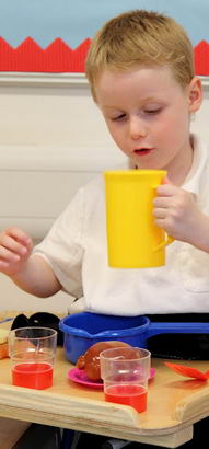 Boy at desk with measuring jug