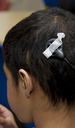 Boy with hearing implant