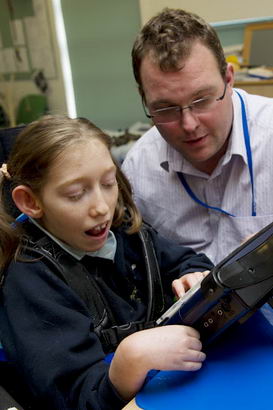 A teacher observes a girl using
                  a communication device
