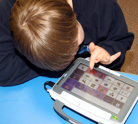 A boy uses a communication aid