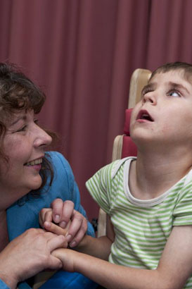 A girl laughing with her teacher