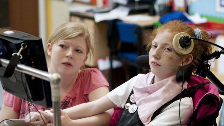 A girl in specialist chair
                  and her teacher
