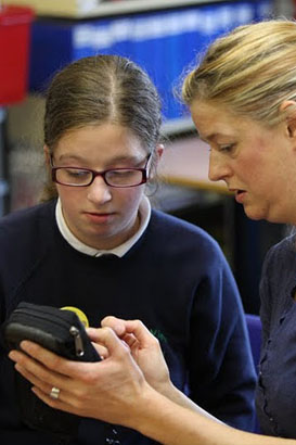 Teacher communicates with teenage girl
                  through handheld