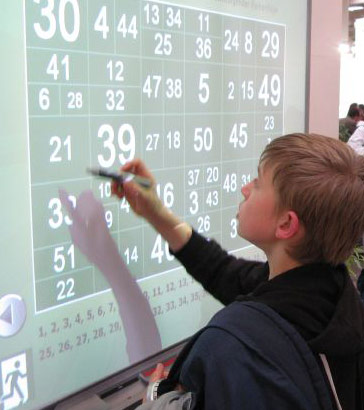 A child uses a whiteboard