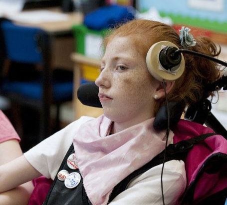 Young boy in chair uses a head operated
                  switch