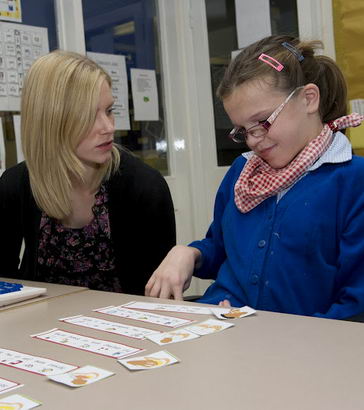 a female pupil and teacher learn
                  side by side using various personalised techniques in a classroom