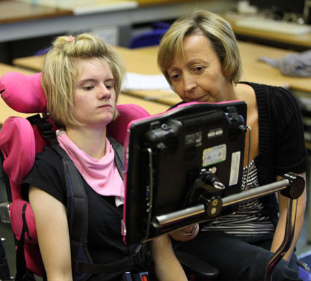 Female teacher with girl at a computer