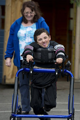 Girl on tricycle with carer
