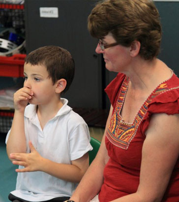 An anxious child holds his head