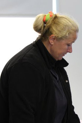 Two teachers comfort a distressed pupil
                  who is using a laptop