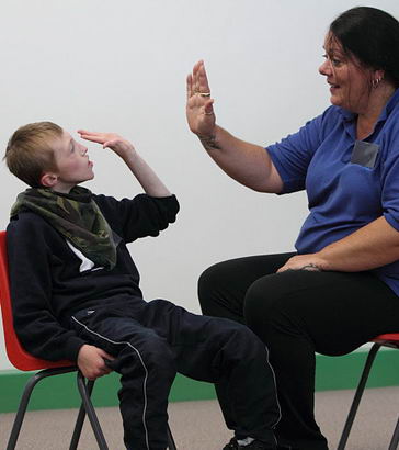 A boy participates in an intensive interaction
                  session
