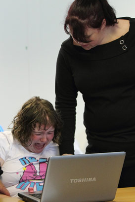 A carer helps to calm a distressed girl