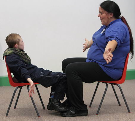 A boy participates in an intensive interaction
                  session