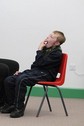 A boy participates in an intensive interaction
                  session