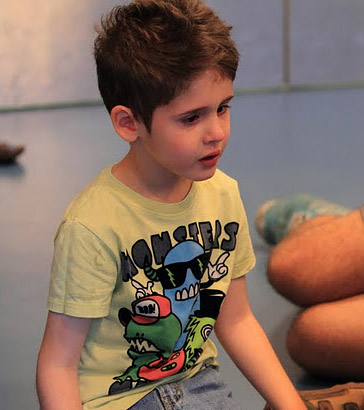A carer calms a distressed boy