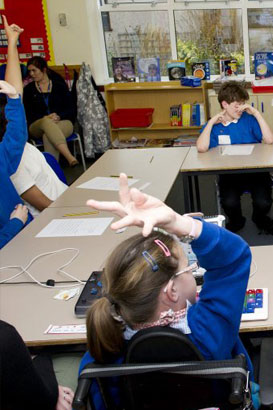 Two pupils raising their hands