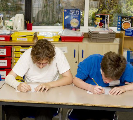 Two members of staff evaluate their assessment
                  policy