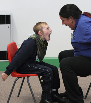 Pupil and adult openmouthed at each other