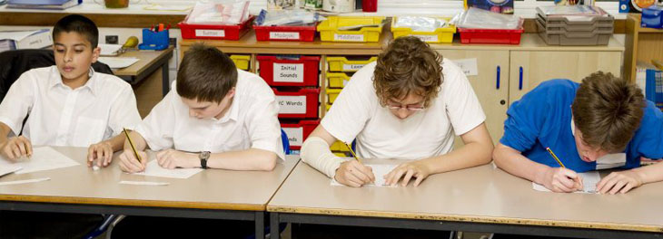 Two members of staff evaluate their assessment
                  policy
