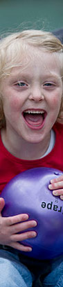 Girl in playground with ball