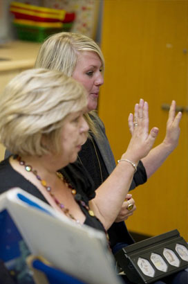 Two teachers looking at a computer screen