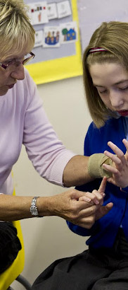 Teacher helping girl.